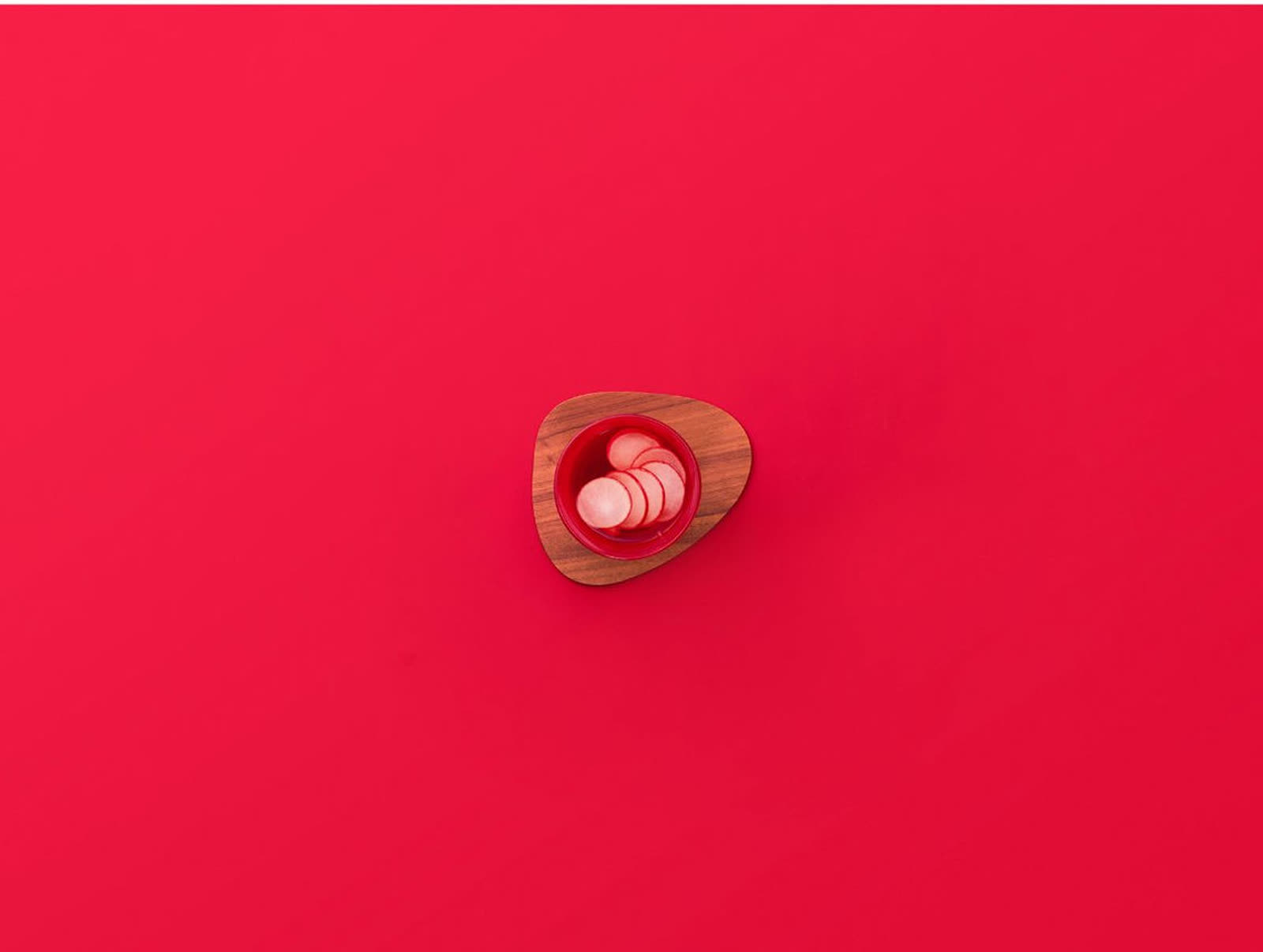 Cremesso cookbook — red backdrop with radishes on wood board