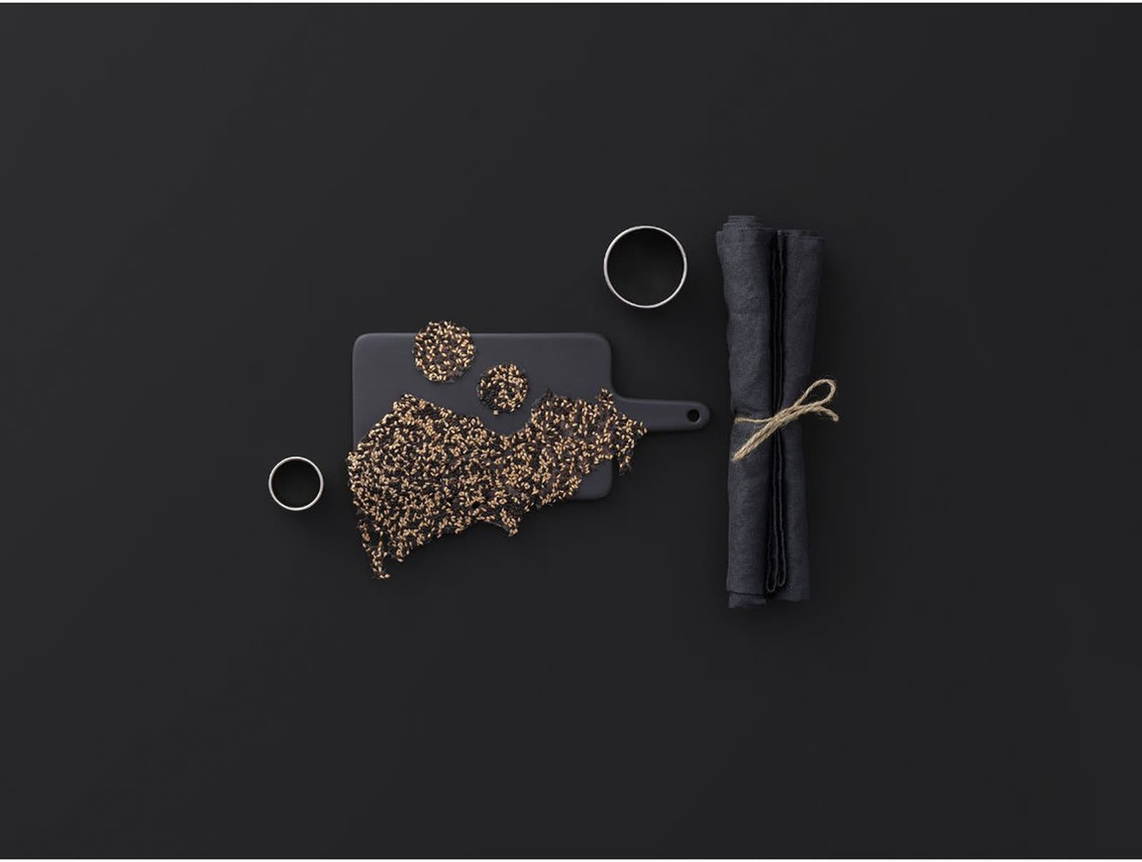 Cremesso cookbook — black backdrop with seeds and linen napkin