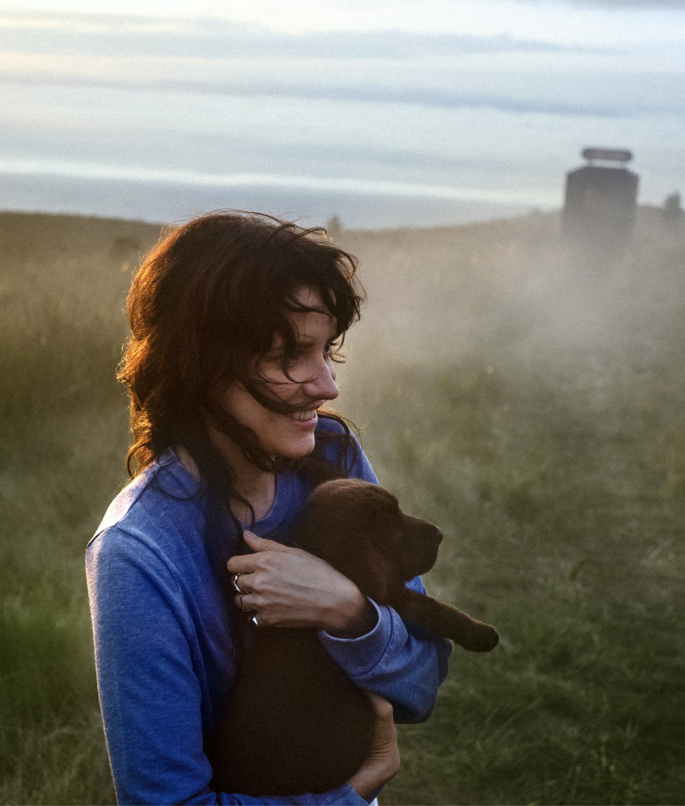 o2 The Contract of Your Life — woman holding puppy at sunset